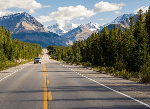 Car driving on the Icefields Parkway road in Canada